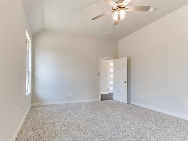 carpeted empty room featuring vaulted ceiling and ceiling fan