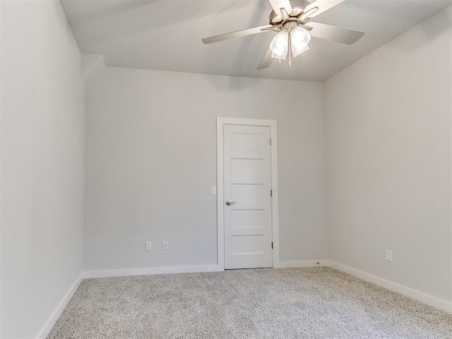 empty room featuring ceiling fan and light carpet