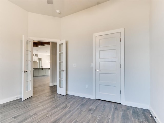 unfurnished bedroom featuring ceiling fan and french doors