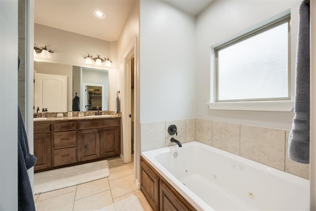 bathroom with tile patterned flooring, vanity, and a washtub