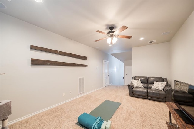 carpeted living room with ceiling fan