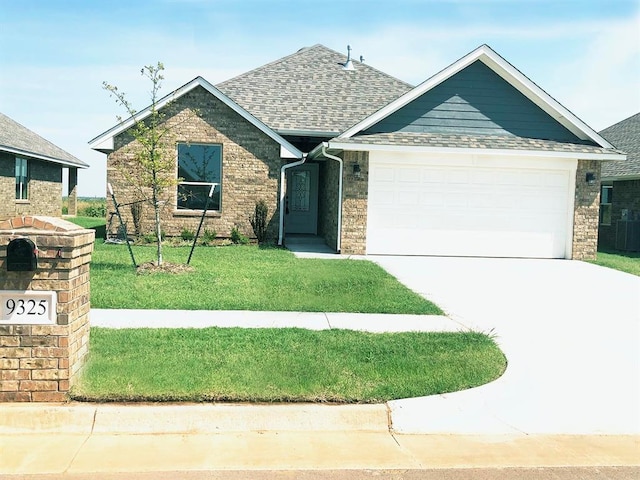 view of front of house featuring a garage and a front lawn