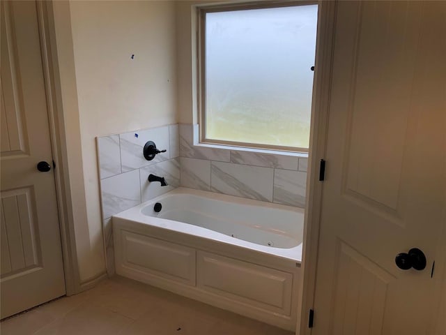 bathroom featuring tile patterned flooring and a bathtub