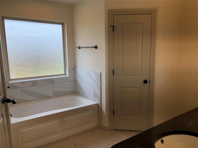 bathroom with vanity and a bathtub