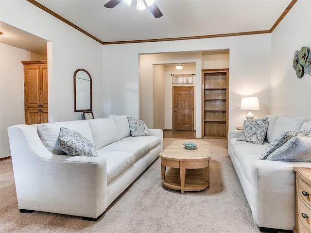 carpeted living room featuring ceiling fan and ornamental molding