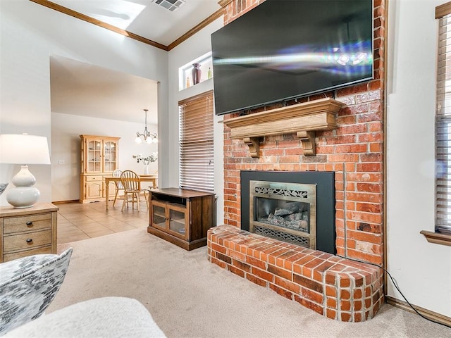 living room with a fireplace, light colored carpet, an inviting chandelier, and crown molding