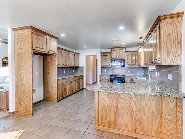 kitchen featuring black appliances, light stone countertops, sink, and tasteful backsplash