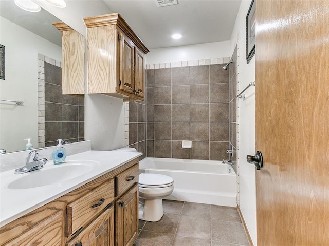 full bathroom with tile patterned flooring, vanity, toilet, and tiled shower / bath