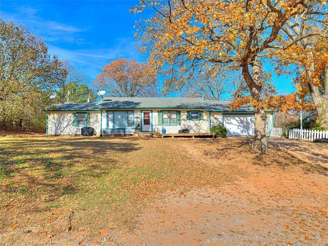 single story home featuring a front yard and a garage