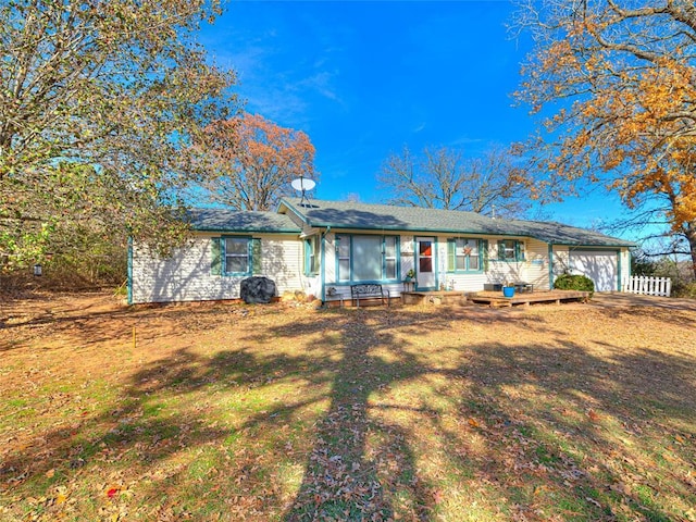 back of house featuring a lawn and a garage