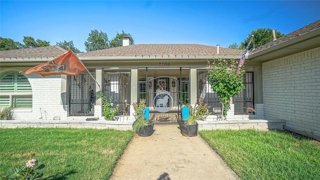 doorway to property with a yard