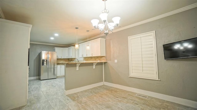 kitchen featuring a kitchen breakfast bar, stainless steel refrigerator with ice dispenser, kitchen peninsula, decorative light fixtures, and white cabinets