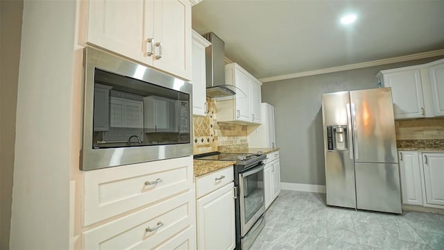 kitchen featuring appliances with stainless steel finishes, tasteful backsplash, light stone counters, wall chimney exhaust hood, and white cabinetry