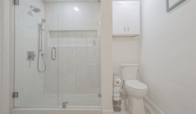 bathroom with toilet and a shower with door