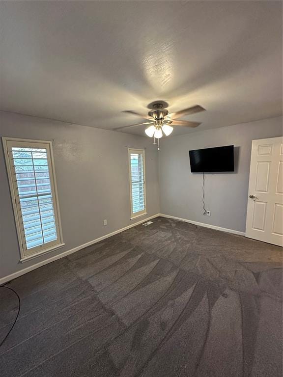 carpeted empty room with ceiling fan