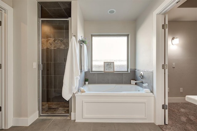 bathroom featuring shower with separate bathtub and tile patterned floors