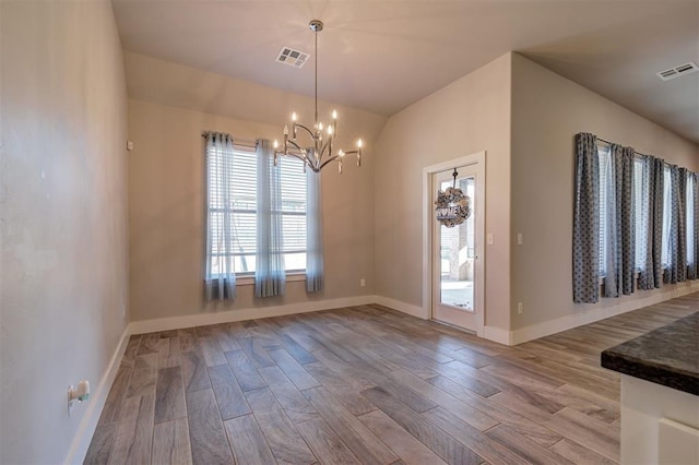 interior space featuring lofted ceiling, a chandelier, and light hardwood / wood-style flooring