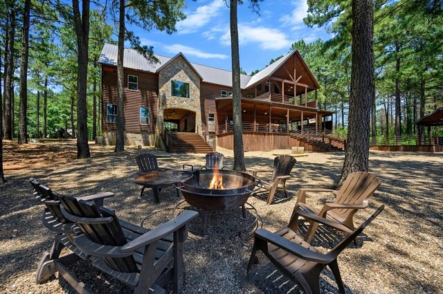 view of patio with a deck and an outdoor fire pit