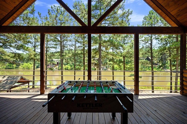 exterior space featuring hardwood / wood-style flooring, a healthy amount of sunlight, and vaulted ceiling