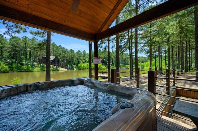 exterior space with a water view, lofted ceiling, a jacuzzi, and wooden ceiling