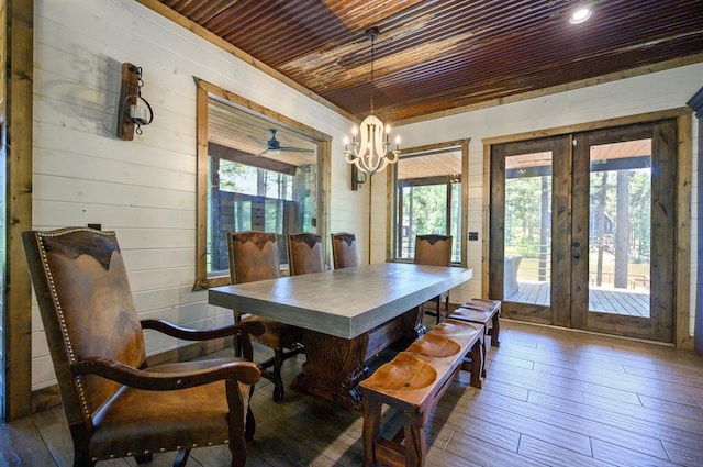 dining area with a healthy amount of sunlight, wooden ceiling, french doors, and dark wood-type flooring