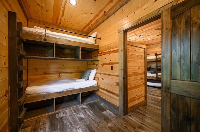 interior space featuring dark hardwood / wood-style floors, wooden walls, and wood ceiling