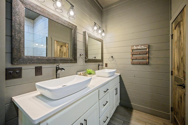 bathroom featuring hardwood / wood-style floors, vanity, and wood walls