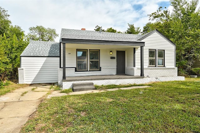 view of front of property with covered porch and a front lawn