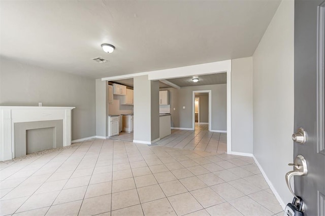 unfurnished living room featuring light tile patterned flooring