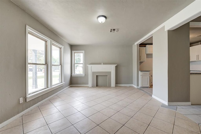 unfurnished living room featuring light tile patterned floors