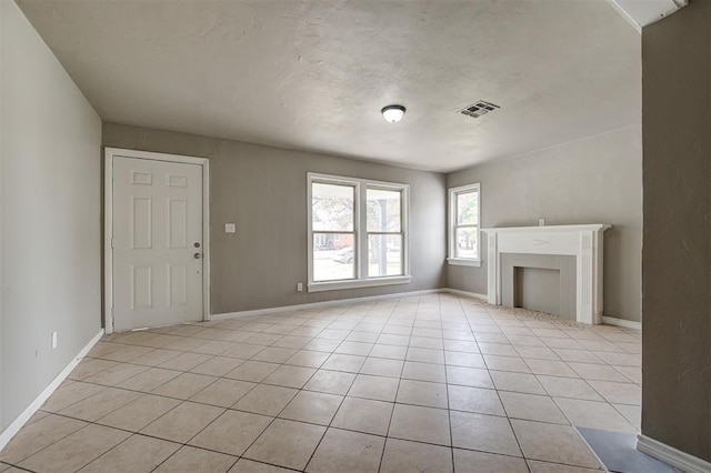 unfurnished living room featuring light tile patterned floors