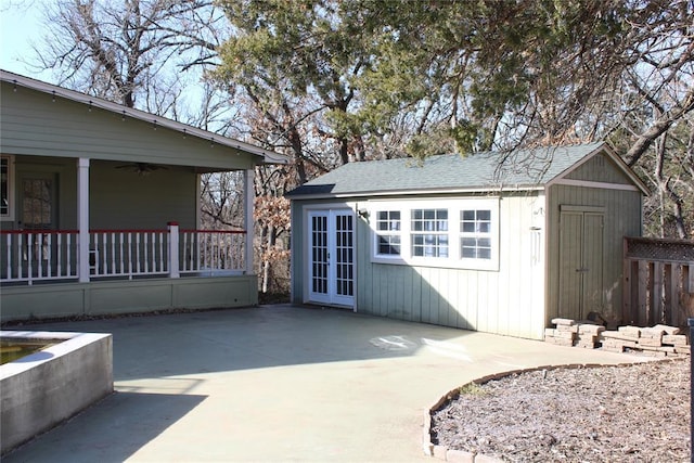 view of outdoor structure featuring french doors and covered porch