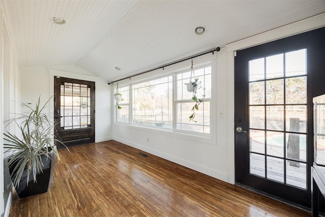 entrance foyer featuring hardwood / wood-style flooring and vaulted ceiling