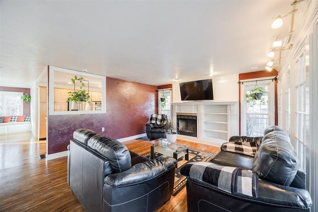 living room with hardwood / wood-style floors and a healthy amount of sunlight