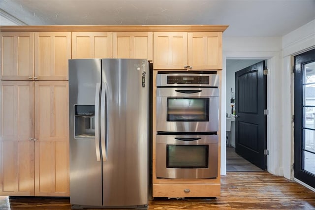 kitchen featuring light brown cabinetry, dark hardwood / wood-style flooring, and stainless steel appliances