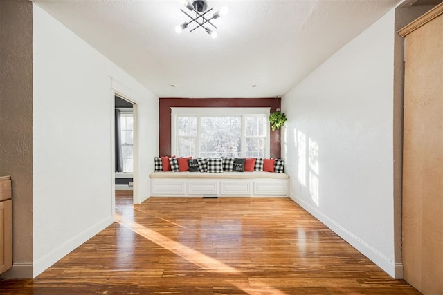 unfurnished living room with wood-type flooring