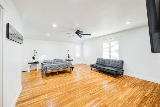 bedroom with ceiling fan and light hardwood / wood-style floors