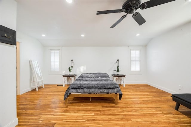 bedroom featuring ceiling fan, light hardwood / wood-style floors, and vaulted ceiling