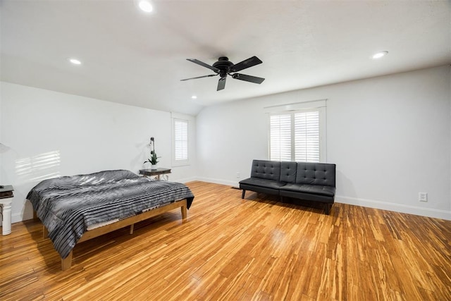 bedroom featuring vaulted ceiling, ceiling fan, and light wood-type flooring