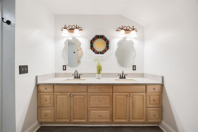 bathroom with vanity and vaulted ceiling