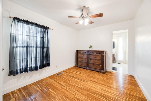 bedroom featuring multiple windows and light hardwood / wood-style flooring