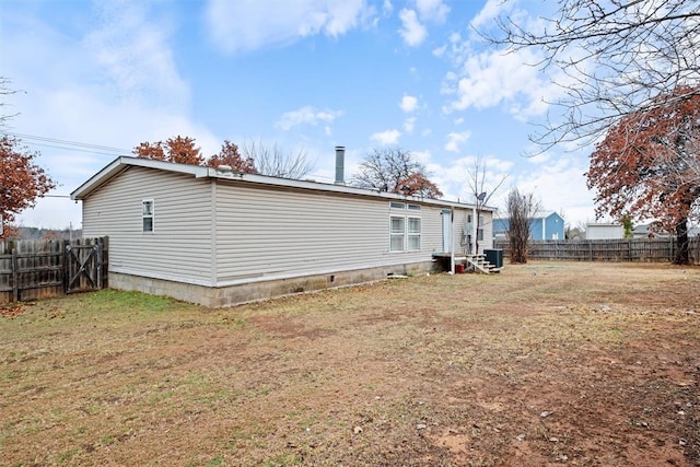 view of property exterior featuring a lawn and central AC unit