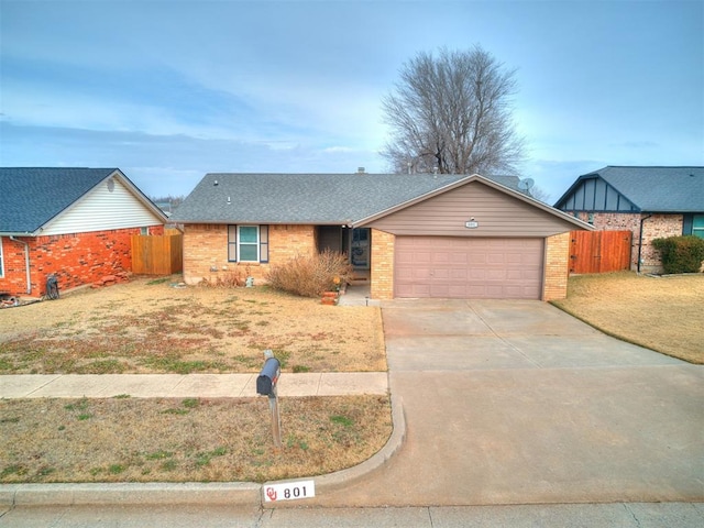 ranch-style home with a garage and a front yard