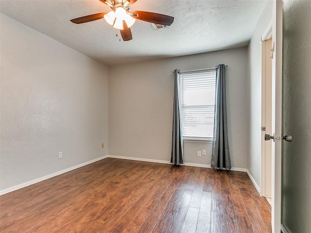 unfurnished room with ceiling fan, dark hardwood / wood-style floors, and a textured ceiling