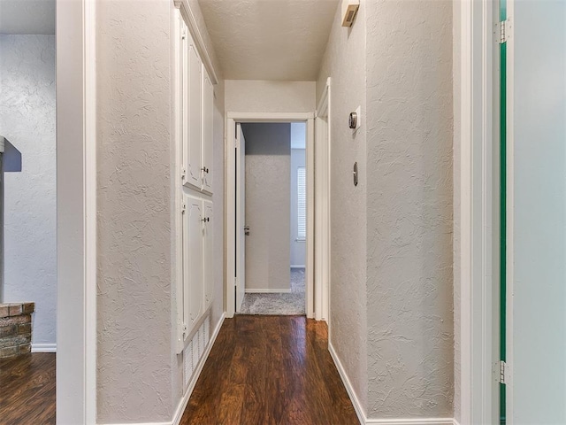 hall with dark hardwood / wood-style flooring