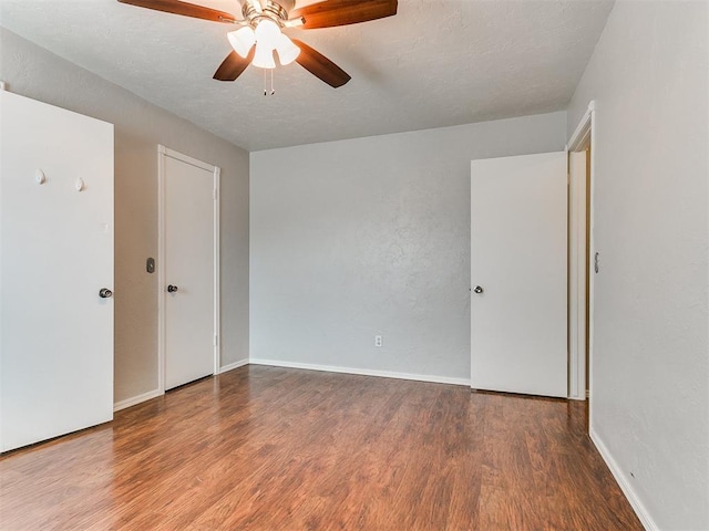 empty room featuring ceiling fan and wood-type flooring