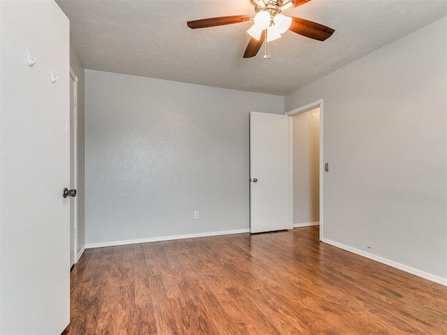 spare room with hardwood / wood-style floors and ceiling fan