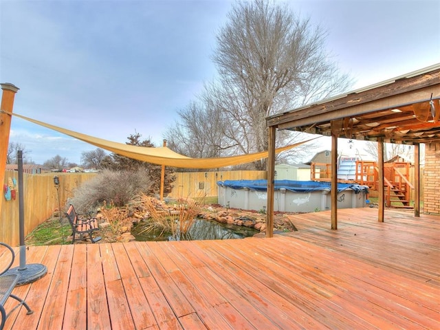 wooden deck featuring a covered pool