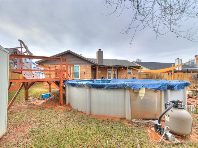 rear view of property with a swimming pool side deck