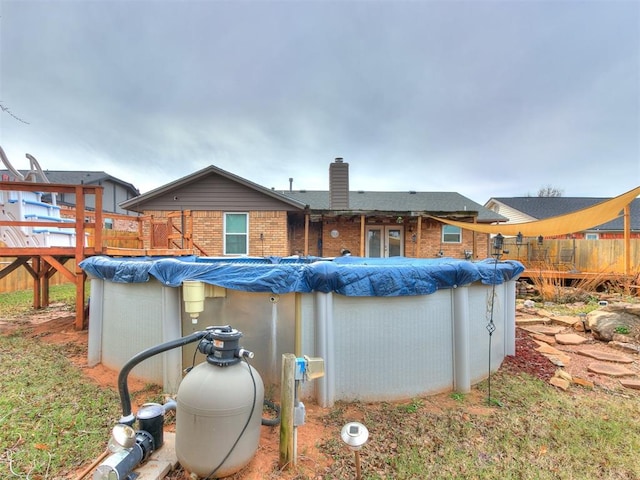 rear view of house with a swimming pool side deck